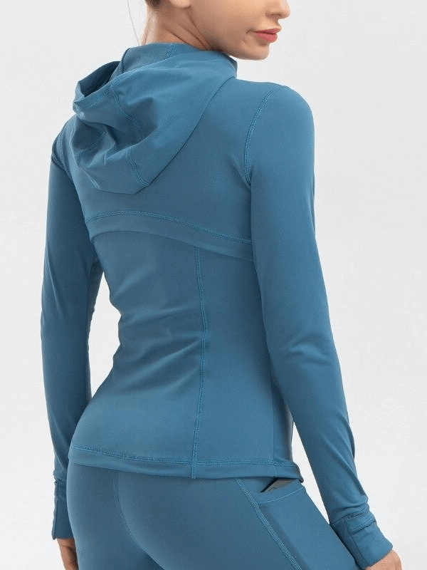 Woman wearing a blue long-sleeve quick-drying sports hoodie perfect for yoga and active workouts.